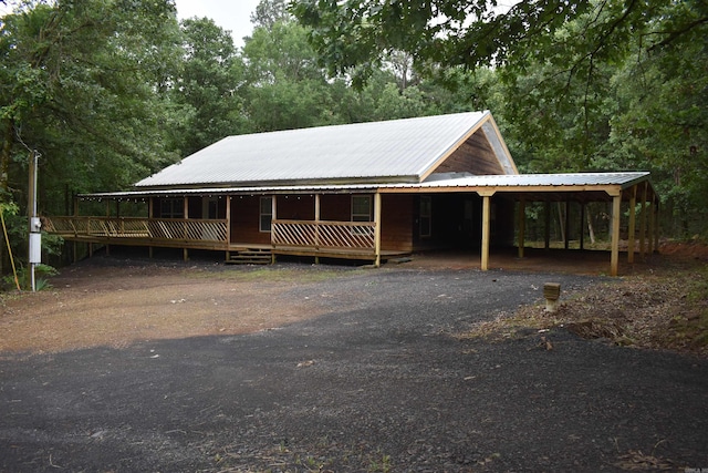 10355 Rodeo Rd, Belleville, AR 72824 - farmhouse featuring a carport, metal roof, and a porch