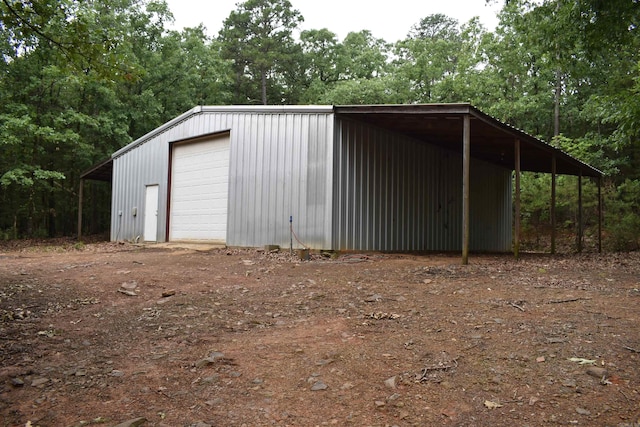 10355 Rodeo Rd, Belleville, AR 72824 - view of outdoor structure featuring dirt driveway and view of wooded area