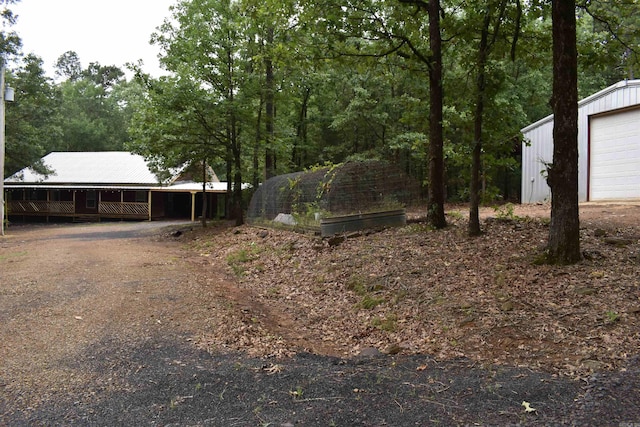 10355 Rodeo Rd, Belleville, AR 72824 - view of yard featuring an outdoor structure and a garage