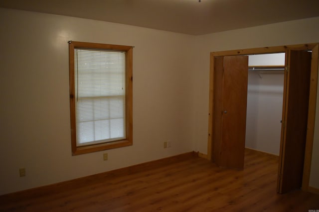 10355 Rodeo Rd, Belleville, AR 72824 - unfurnished bedroom featuring wood finished floors and a closet