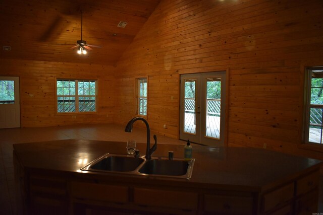 10355 Rodeo Rd, Belleville, AR 72824 - kitchen featuring a sink, open floor plan, ceiling fan, lofted ceiling, and wood walls