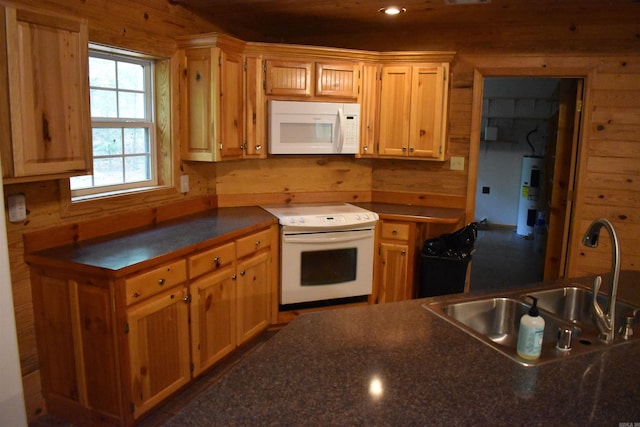 10355 Rodeo Rd, Belleville, AR 72824 - kitchen featuring white appliances, a sink, water heater, dark countertops, and wooden walls