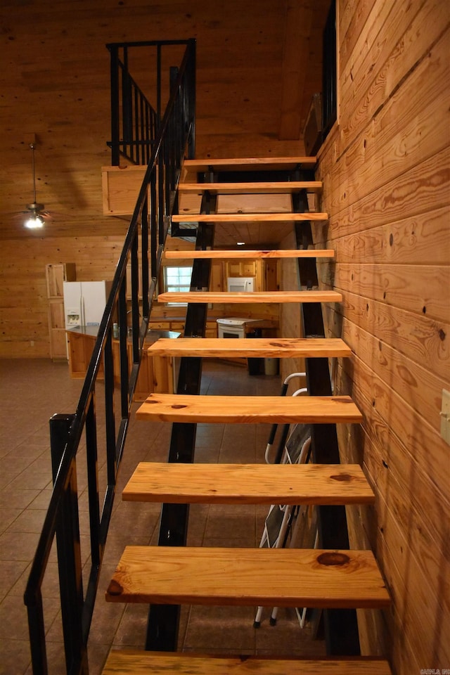 10355 Rodeo Rd, Belleville, AR 72824 - stairway featuring wood walls, a ceiling fan, and tile patterned flooring