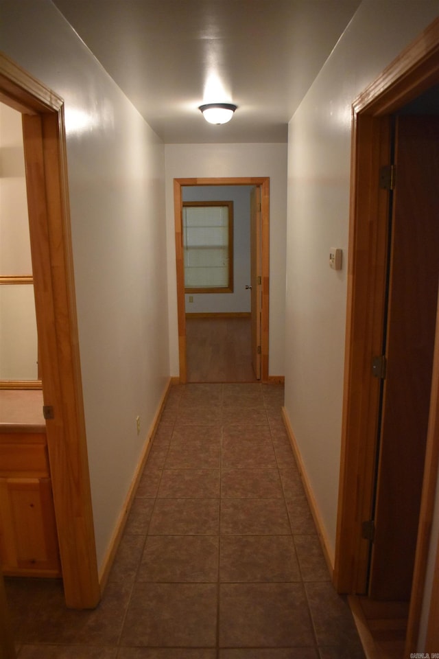 10355 Rodeo Rd, Belleville, AR 72824 - corridor with baseboards and dark tile patterned flooring