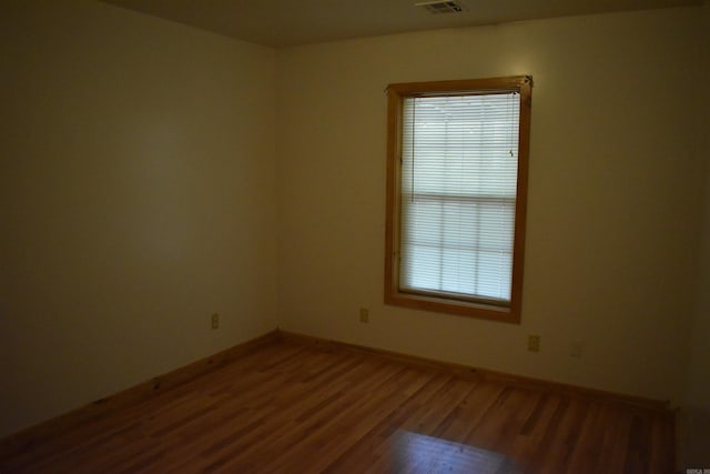 10355 Rodeo Rd, Belleville, AR 72824 - empty room featuring healthy amount of natural light, wood finished floors, and baseboards