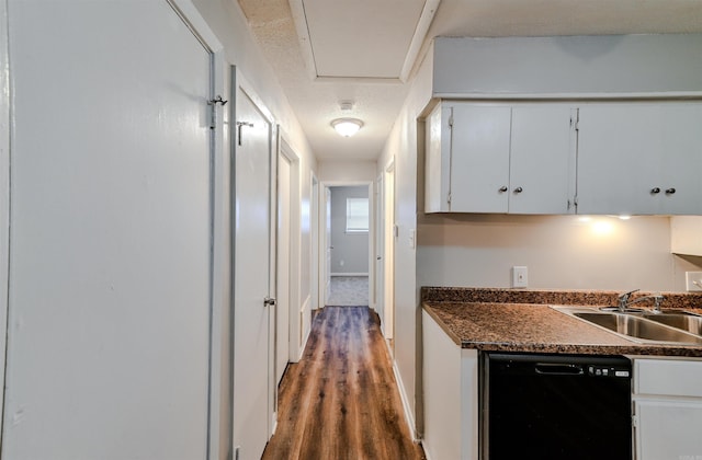 7710 Bradley Dr, Little Rock, AR 72209 - kitchen with black dishwasher, white cabinets, wood finished floors, dark countertops, and a textured ceiling