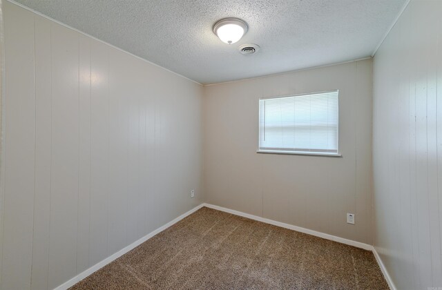 7710 Bradley Dr, Little Rock, AR 72209 - carpeted empty room featuring a textured ceiling, baseboards, and crown molding