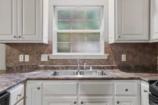 7106 Ohio St Unit 6, Little Rock, AR 72207 - kitchen featuring a sink, white cabinets, tasteful backsplash, and dark countertops