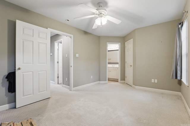 7106 Ohio St Unit 6, Little Rock, AR 72207 - unfurnished bedroom featuring light carpet, baseboards, a ceiling fan, and ensuite bathroom