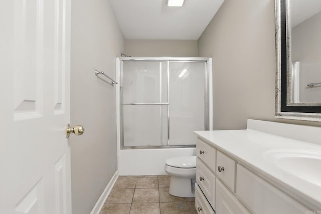 7106 Ohio St Unit 6, Little Rock, AR 72207 - bathroom featuring vanity, toilet, shower / bath combination with glass door, baseboards, and tile patterned flooring