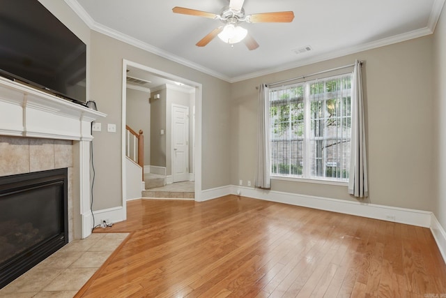 7106 Ohio St Unit 6, Little Rock, AR 72207 - unfurnished living room with hardwood / wood-style flooring, a fireplace, crown molding, stairs, and a ceiling fan