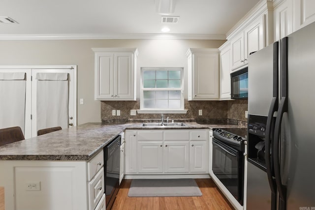 7106 Ohio St Unit 6, Little Rock, AR 72207 - kitchen featuring black appliances, a sink, a peninsula, crown molding, and white cabinetry