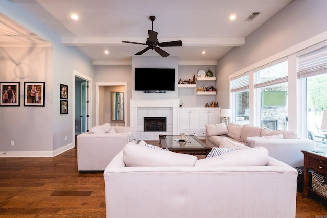 853 Rushing Rd, Little Rock, AR 72210 - living area with beam ceiling, a ceiling fan, a tile fireplace, dark wood-style flooring, and baseboards