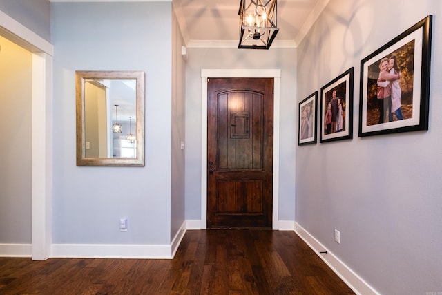 853 Rushing Rd, Little Rock, AR 72210 - entrance foyer with a chandelier, baseboards, and dark wood-style flooring