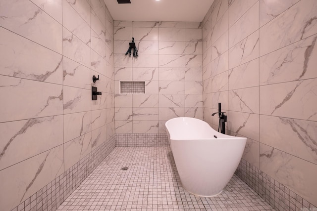 2103 Wolfe St, Little Rock, AR 72202 - bathroom featuring a soaking tub and tile walls