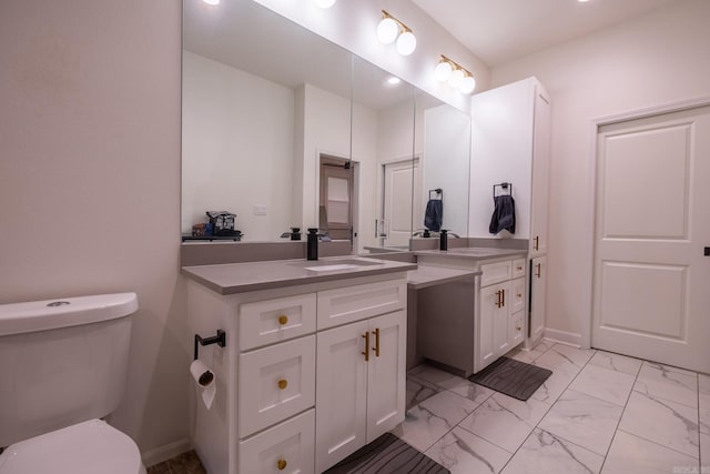 2103 Wolfe St, Little Rock, AR 72202 - bathroom featuring two vanities, marble look tile flooring, baseboards, toilet, and recessed lighting