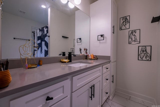 2103 Wolfe St, Little Rock, AR 72202 - bathroom featuring vanity, marble finish floors, and baseboards