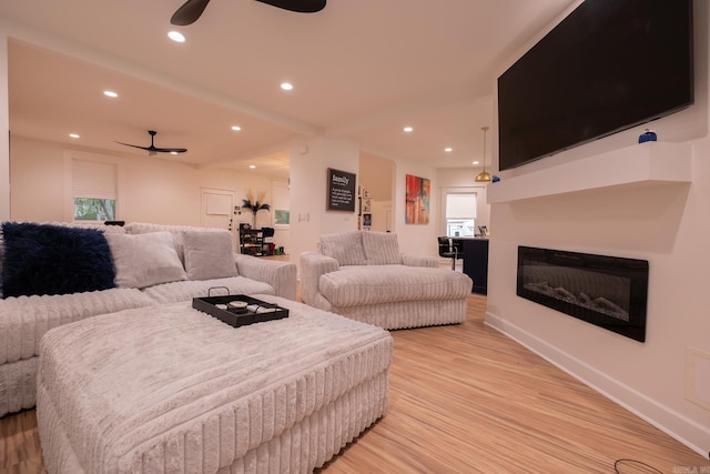 2103 Wolfe St, Little Rock, AR 72202 - living area featuring a ceiling fan, light wood-type flooring, recessed lighting, a glass covered fireplace, and baseboards