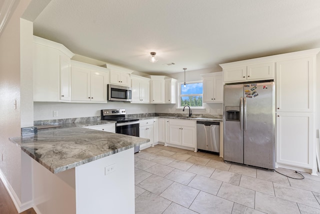 15987 E Miller Sardis Rd, Bauxite, AR 72011 - kitchen with stainless steel appliances, a peninsula, and white cabinets