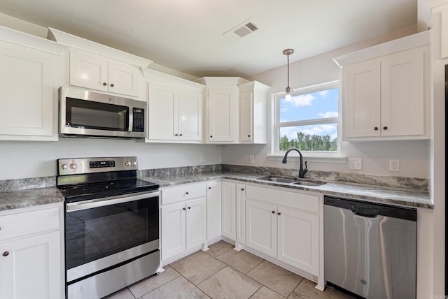 15987 E Miller Sardis Rd, Bauxite, AR 72011 - kitchen featuring stainless steel appliances, a sink, white cabinetry, light tile patterned flooring, and decorative light fixtures