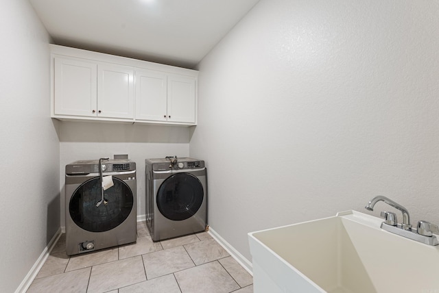 15987 E Miller Sardis Rd, Bauxite, AR 72011 - laundry area featuring washer and clothes dryer, cabinet space, light tile patterned floors, and baseboards