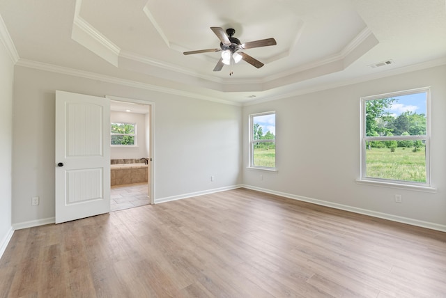 15987 E Miller Sardis Rd, Bauxite, AR 72011 - empty room featuring a raised ceiling, plenty of natural light, ceiling fan, crown molding, and light wood finished floors