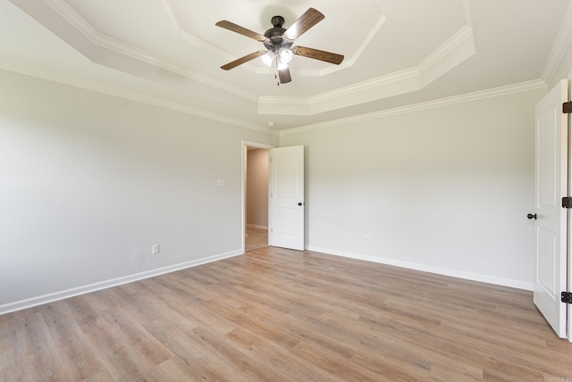 15987 E Miller Sardis Rd, Bauxite, AR 72011 - empty room featuring a tray ceiling, ceiling fan, light wood-style floors, ornamental molding, and baseboards