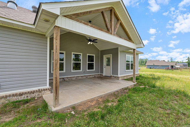 15987 E Miller Sardis Rd, Bauxite, AR 72011 - view of exterior entry with ceiling fan, a patio area, and a yard