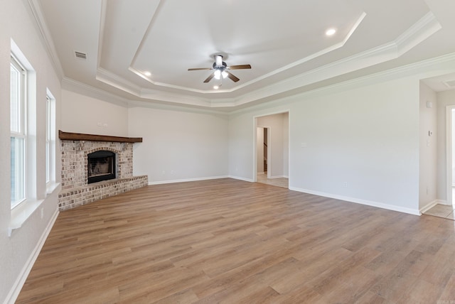 15987 E Miller Sardis Rd, Bauxite, AR 72011 - unfurnished living room with a raised ceiling, ceiling fan, light wood-type flooring, crown molding, and a fireplace