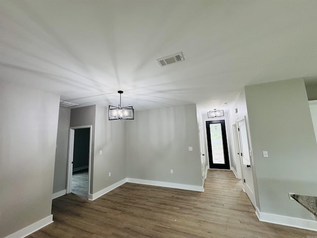 207 W Military Rd, North Little Rock, AR 72118 - unfurnished dining area with wood finished floors, baseboards, and a chandelier
