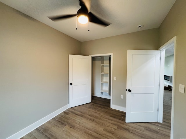 207 W Military Rd, North Little Rock, AR 72118 - unfurnished bedroom with wood finished floors, baseboards, ceiling fan, and a closet
