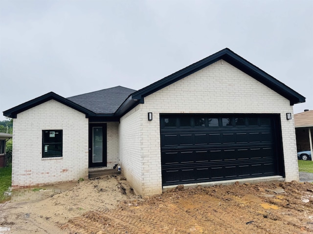 207 W Military Rd, North Little Rock, AR 72118 - ranch-style home featuring brick siding, an attached garage, and a shingled roof