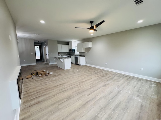 207 W Military Rd, North Little Rock, AR 72118 - unfurnished living room with light wood-style flooring, baseboards, ceiling fan, and recessed lighting
