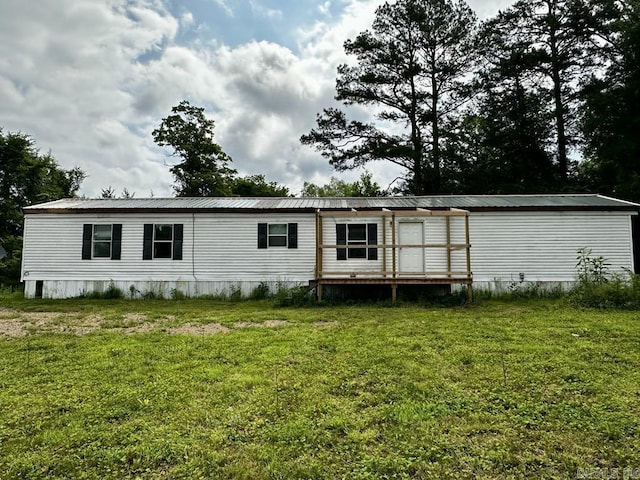 4530 Hwy 8 E, Mena, AR 71953 - rear view of property featuring a lawn and metal roof