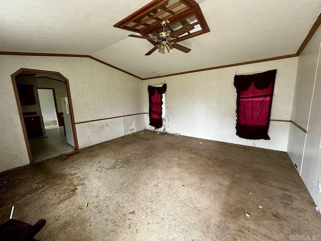 4530 Hwy 8 E, Mena, AR 71953 - empty room featuring a ceiling fan, vaulted ceiling, ornamental molding, arched walkways, and carpet flooring