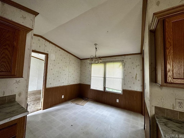 4530 Hwy 8 E, Mena, AR 71953 - unfurnished dining area with a wainscoted wall, lofted ceiling, ornamental molding, wallpapered walls, and a chandelier