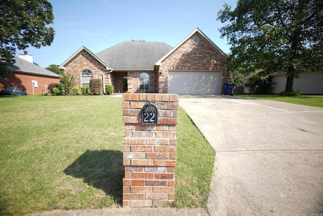 view of front of property with brick siding, a garage, concrete driveway, and a front lawn