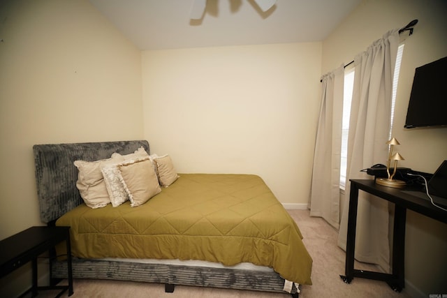bedroom featuring light carpet, ceiling fan, and baseboards