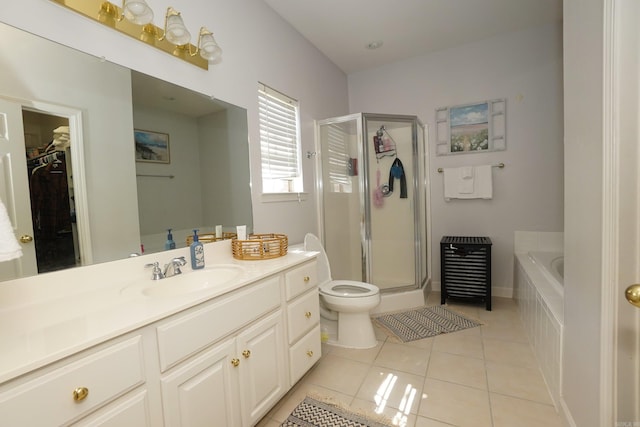 full bathroom with a shower stall, vanity, a garden tub, tile patterned floors, and toilet