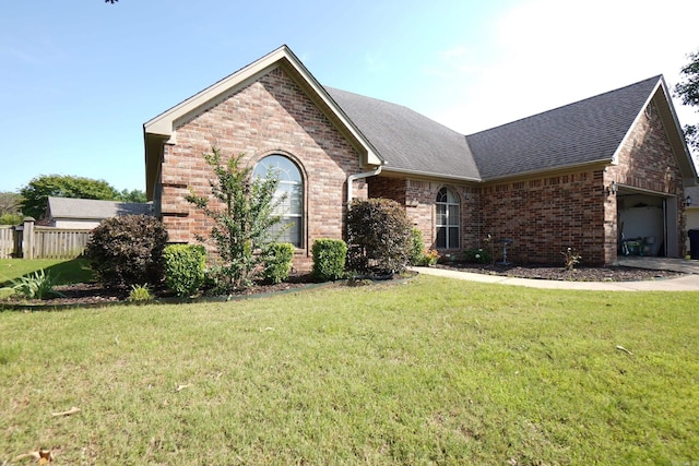 ranch-style home featuring brick siding, roof with shingles, and a garage
