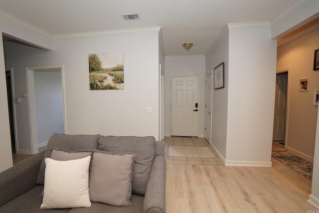 living area with crown molding, light wood finished floors, and baseboards