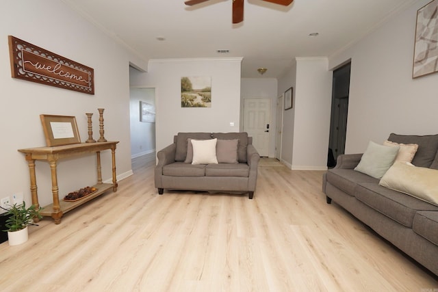 living room featuring crown molding, wood finished floors, ceiling fan, and baseboards