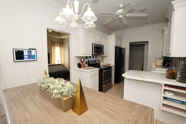 kitchen with stainless steel appliances, white cabinetry, a chandelier, a sink, and light tile patterned floors
