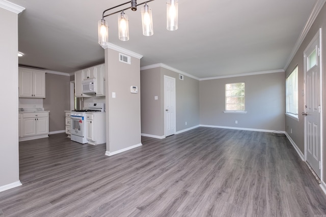 202 Gilbert Dr, Little Rock, AR 72205 - unfurnished living room with wood finished floors, baseboards, and ornamental molding