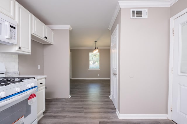 202 Gilbert Dr, Little Rock, AR 72205 - kitchen featuring white appliances, ornamental molding, white cabinets, dark wood-type flooring, and tasteful backsplash