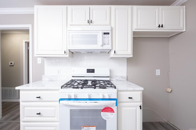 202 Gilbert Dr, Little Rock, AR 72205 - kitchen featuring white appliances, tasteful backsplash, white cabinetry, light stone counters, and dark wood-style floors