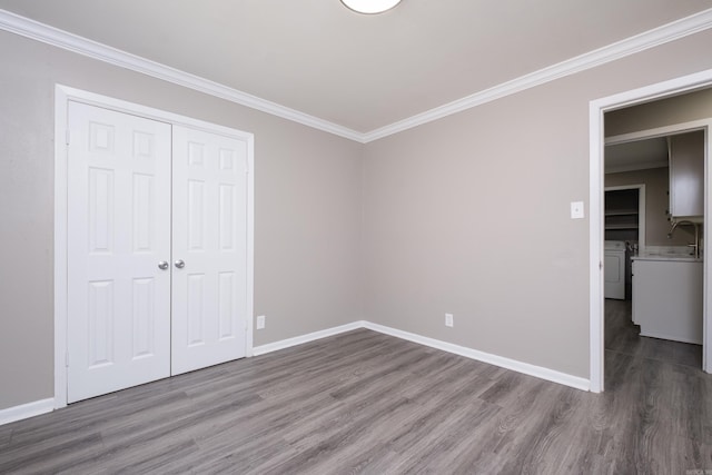 202 Gilbert Dr, Little Rock, AR 72205 - unfurnished bedroom featuring independent washer and dryer, wood finished floors, crown molding, a closet, and baseboards