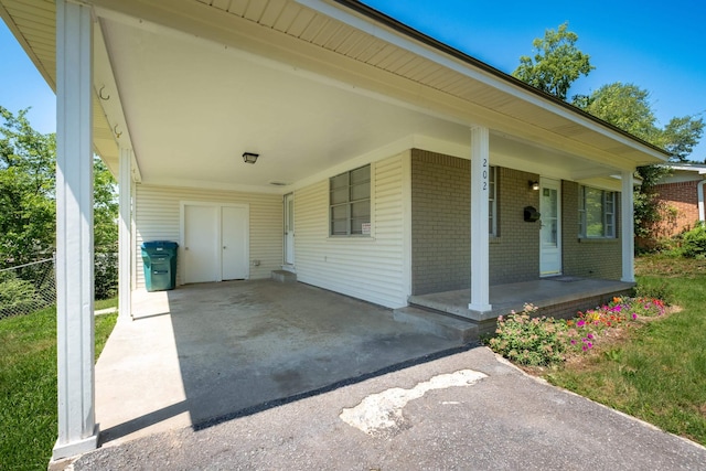 202 Gilbert Dr, Little Rock, AR 72205 - covered porch featuring a carport and asphalt driveway