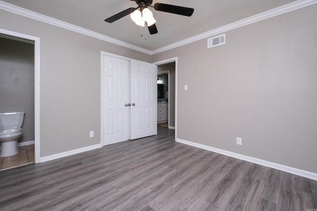 202 Gilbert Dr, Little Rock, AR 72205 - unfurnished bedroom featuring ornamental molding, baseboards, wood finished floors, ceiling fan, and ensuite bathroom