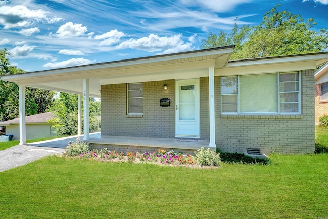 202 Gilbert Dr, Little Rock, AR 72205 - view of front of house with a porch, an attached carport, a front yard, brick siding, and driveway